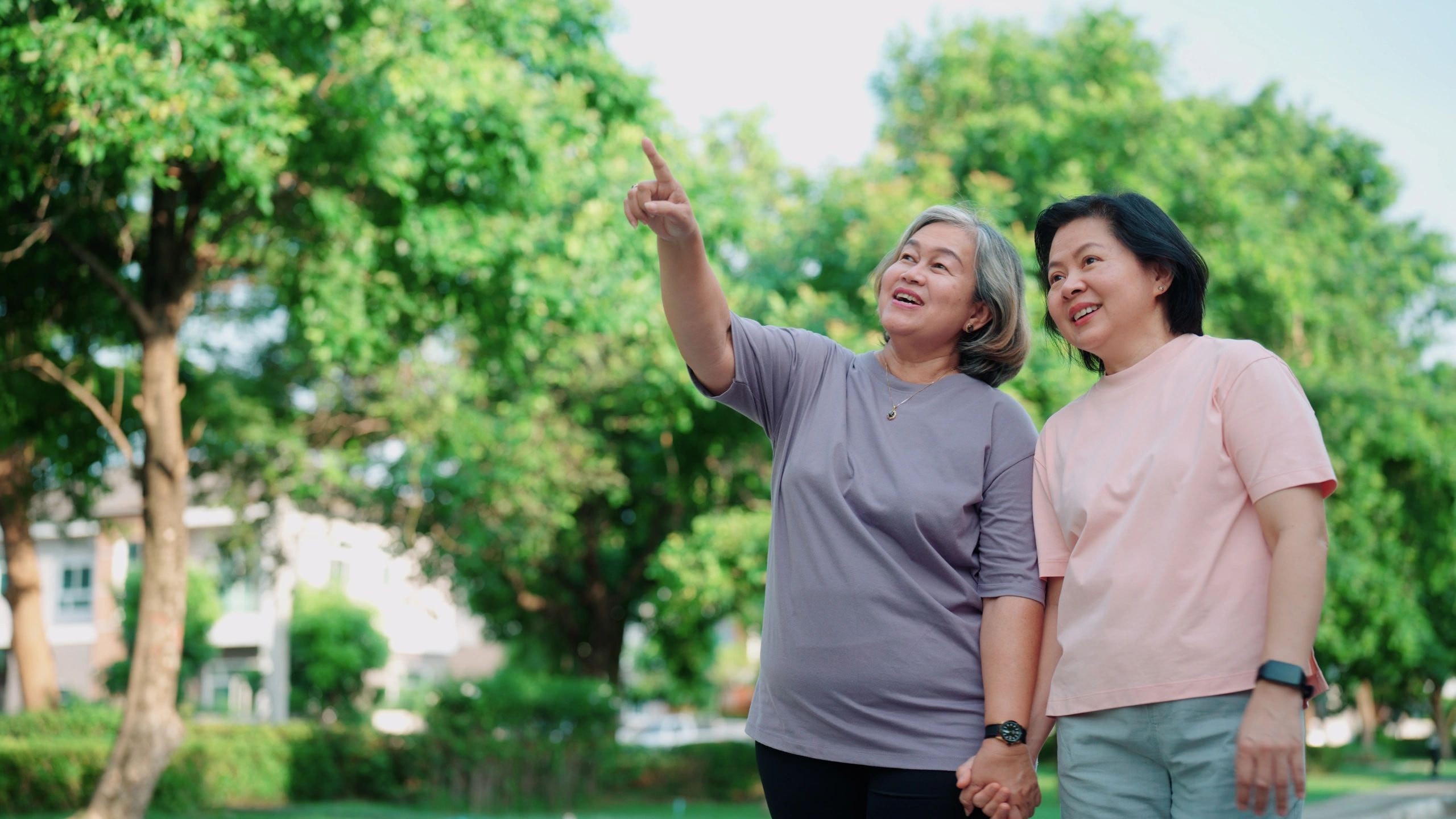 Two women outdoors smiling in a park