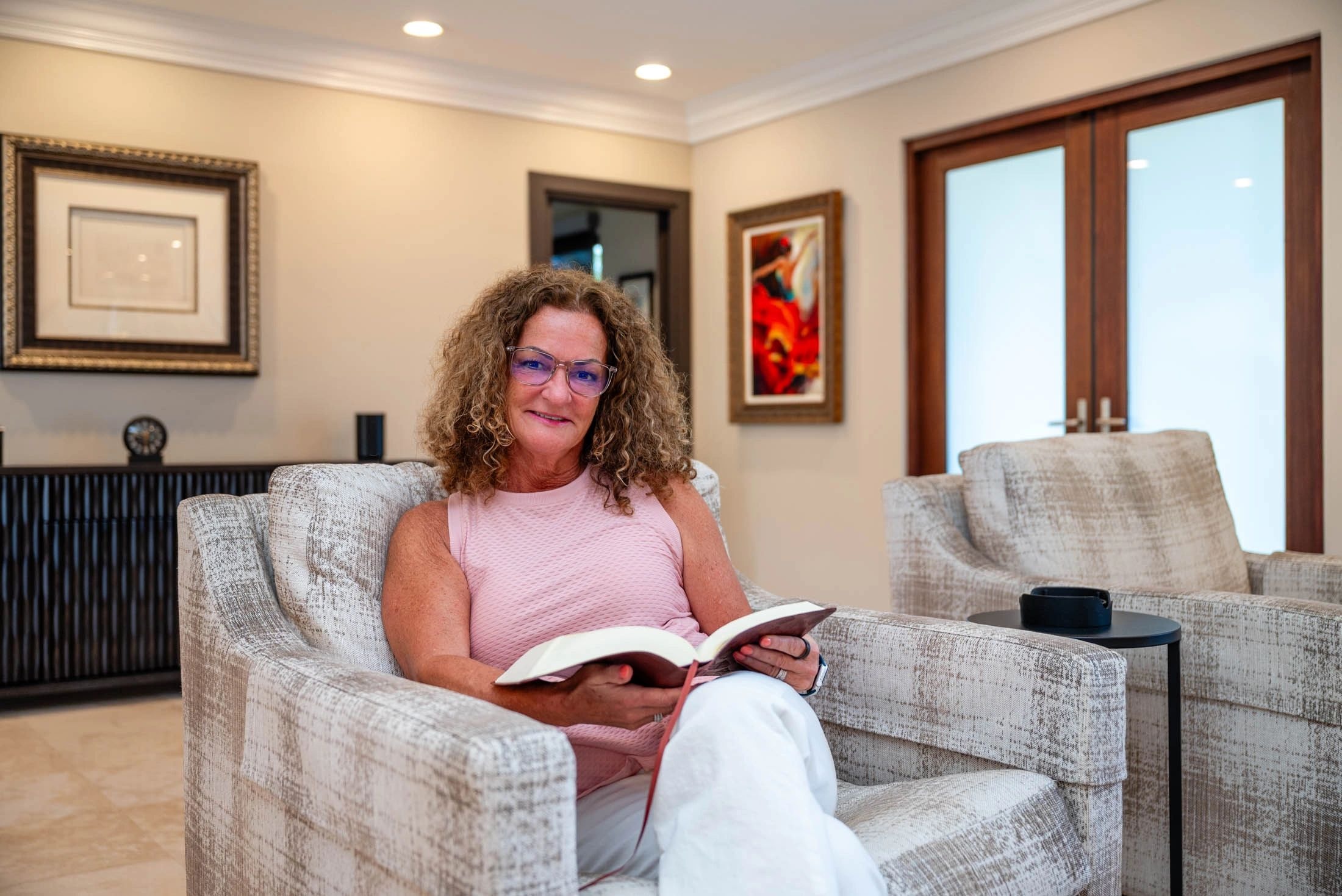 Senior woman reading in a comfortable living room